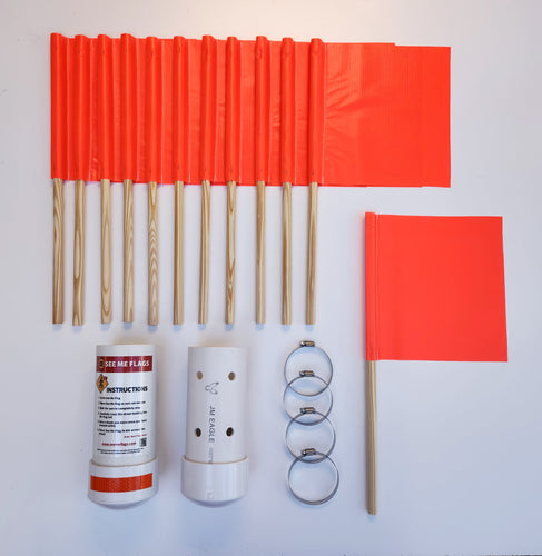 A See Me Flag Starter Set of orange non-reflective crosswalk flags with wooden sticks, storage bins, reflective tape, and attachment devices for street signs.
