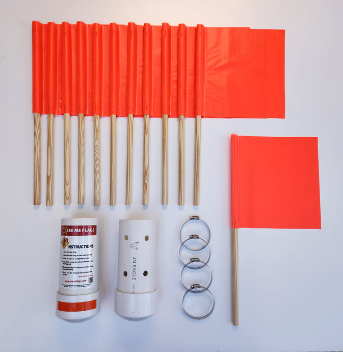 A See Me Flag Starter Set of orange non-reflective crosswalk flags with wooden sticks, storage bins, reflective tape, and attachment devices for street signs.